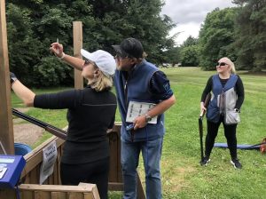 BW Clay Shooting - Brent - our expert shooting instructor -giving lessons to a female client in a white hat.