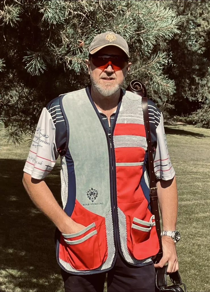 Brent Woodard styling the Roar Shooting red and grey shooting jacket, designed for optimal performance and comfort in shooting sports.